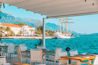 cafe with beautiful view at blue sea water. mountains on background. summer time cafe with beautiful view at blue sea water. mountains on background. summer time
