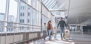 Family transiting through the airport terminal Family transiting through the airport terminal