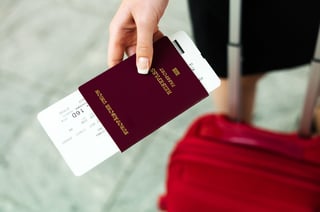 woman with passport and airline tickets at an airport