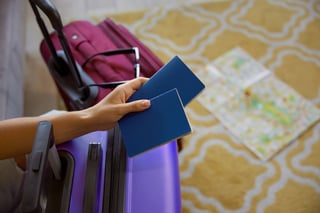 closeup cropped shot of female hand holding two passports