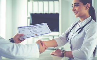 doctor shakes hands with a patient