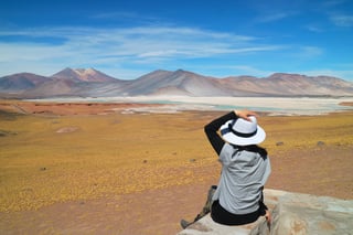 female traveler being impressed of salar de talar salt lakes in atacama desert