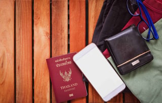 top view of clothing and pants with travel essentials