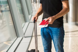 Handing over boarding pass and passport to embark on flight in an airport