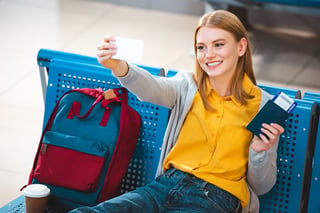 Woman holding passport and phone with QR code about vaccination