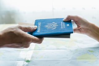 Pretty Travel Agent Giving Tickets To Client On Map