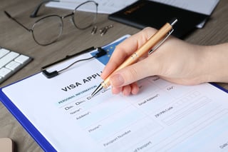 Woman Filling Visa Application Form For Immigration To European Union