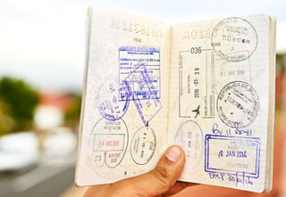 Young Man Holding Open A Passport