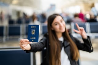 Young Woman Holding Ukraine Passport In Terminal