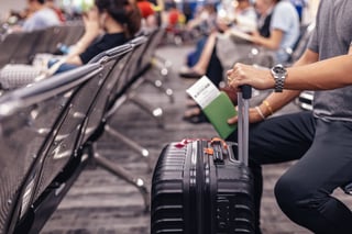 People Sitting And Waiting For Check In At Airport A Man And Luggage