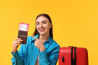 Woman With Tickets Passport And Suitcase On Orange Background